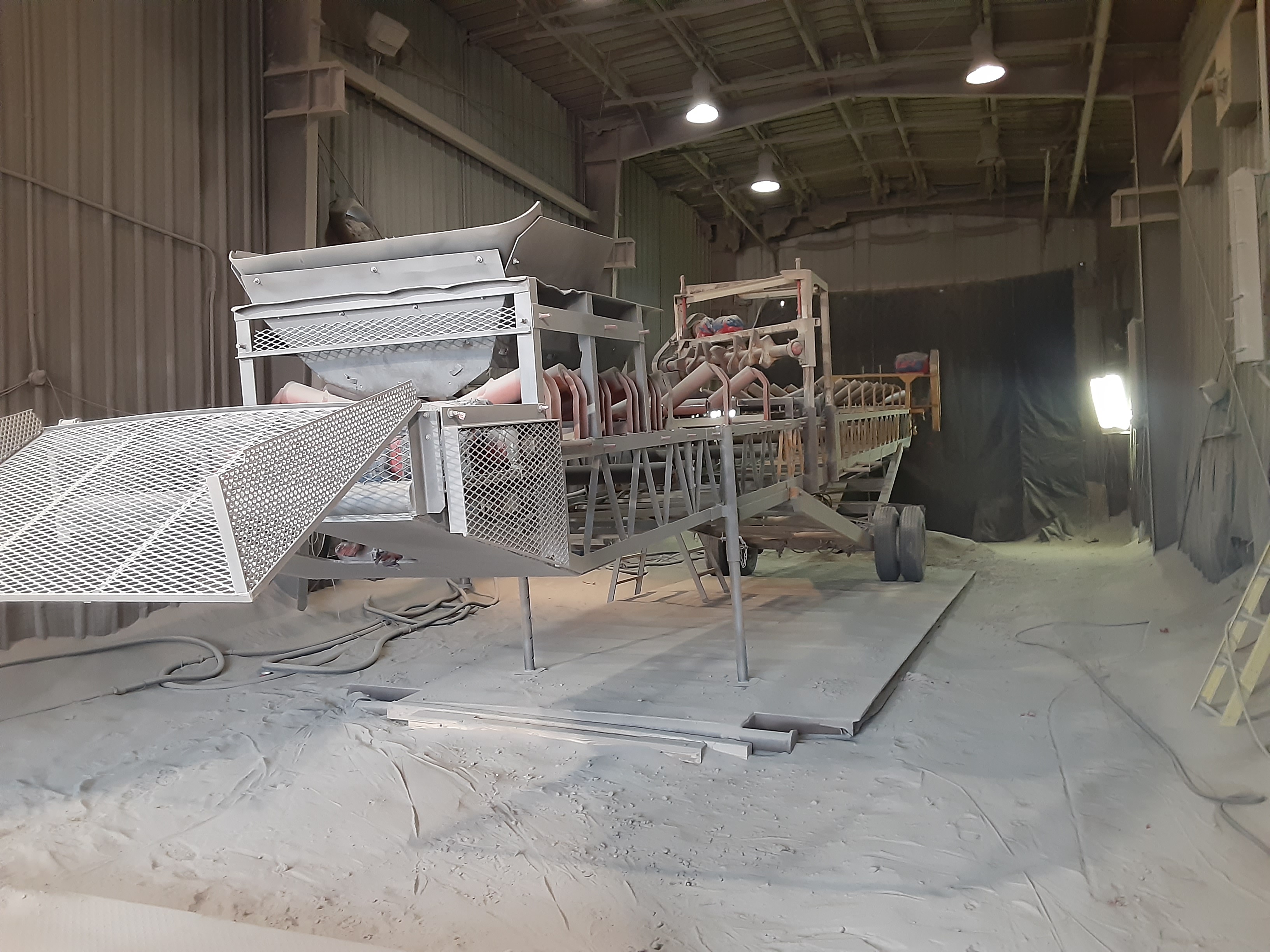 A conveyor being blasted prior to respray
